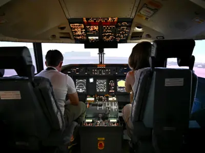 Two people in the Aviation SIM at the Waterloo Wellington Flight Centre